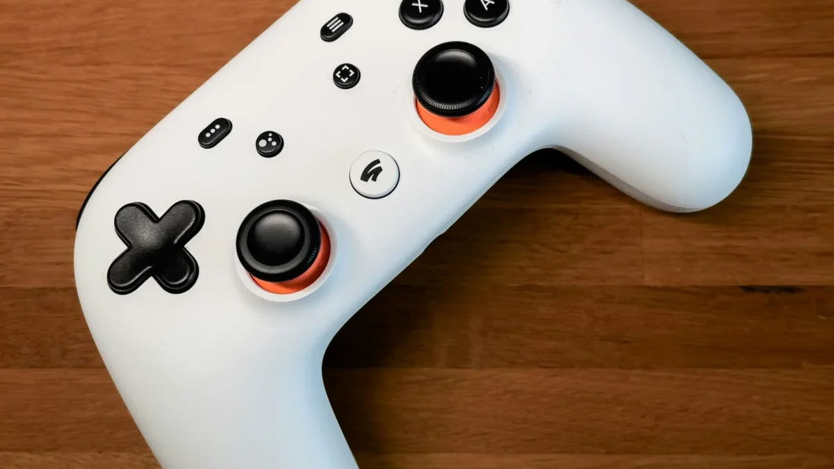 a white controller sitting on top of a wooden floor